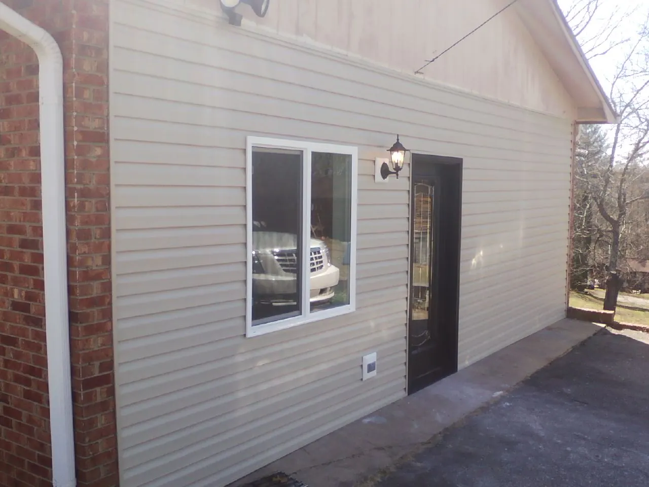 New vinyl siding and entry door on a room addition in Whitehouse